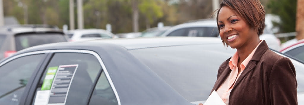 Woman looking at new and used cars