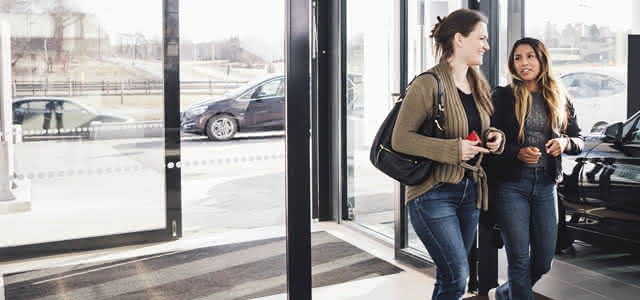 Women discussing car refinancing options